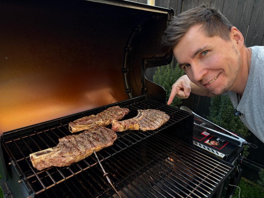 Steaks searing over direct flame on a wood pellet grill