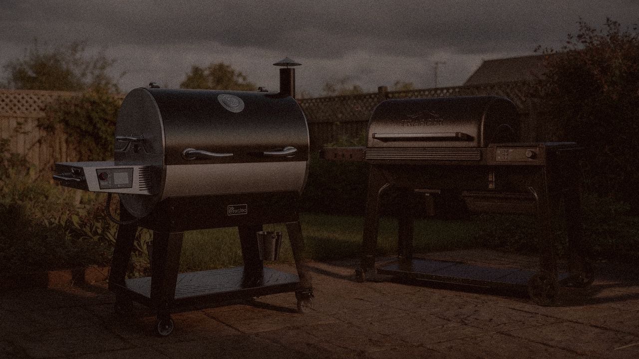 recteq Flagship 1600 and Traeger Ironwood at night with smoke, wood pellet grills on a dark patio